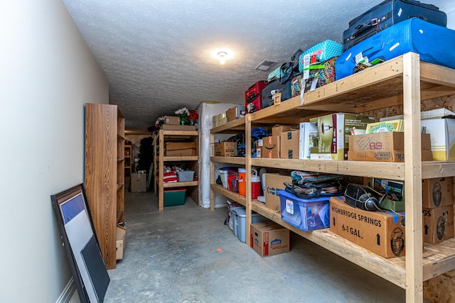 basement with a textured ceiling and water heater