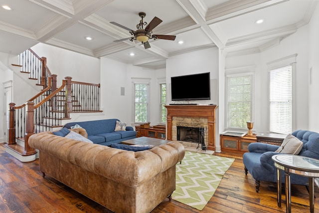 kitchen with a kitchen island with sink, pendant lighting, ornamental molding, stainless steel appliances, and sink