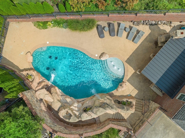 view of pool featuring pool water feature and a patio area