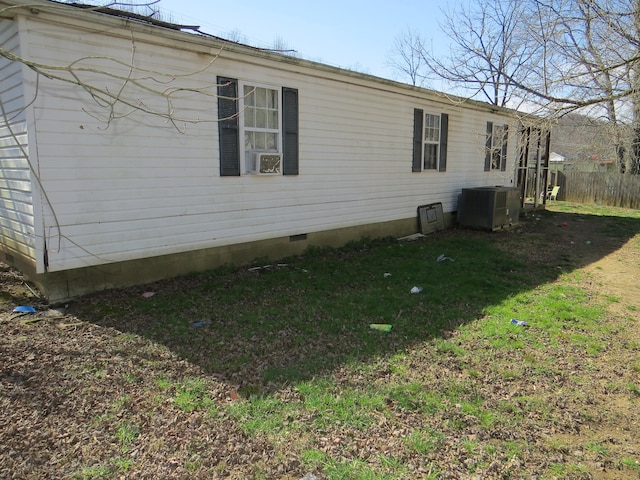 view of property exterior featuring central AC and a lawn