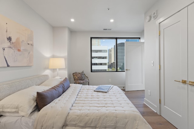 bedroom with dark wood-type flooring