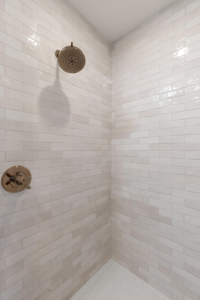 bathroom with tiled shower