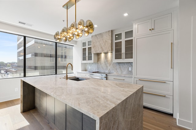 kitchen featuring stainless steel range with electric stovetop, sink, decorative light fixtures, white cabinetry, and dark hardwood / wood-style flooring