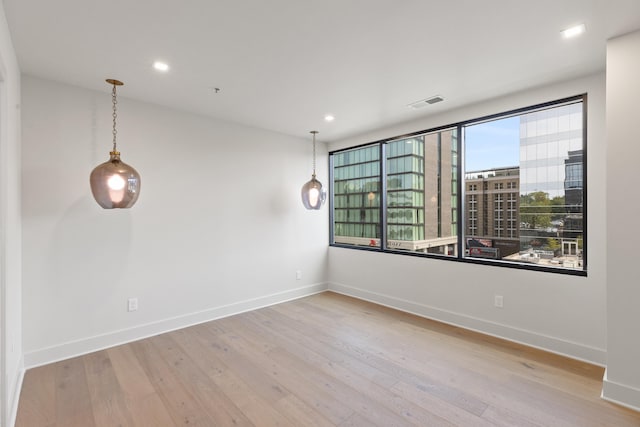 unfurnished room with light wood-type flooring