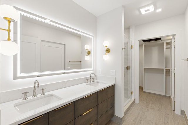 bathroom featuring vanity, hardwood / wood-style flooring, and an enclosed shower