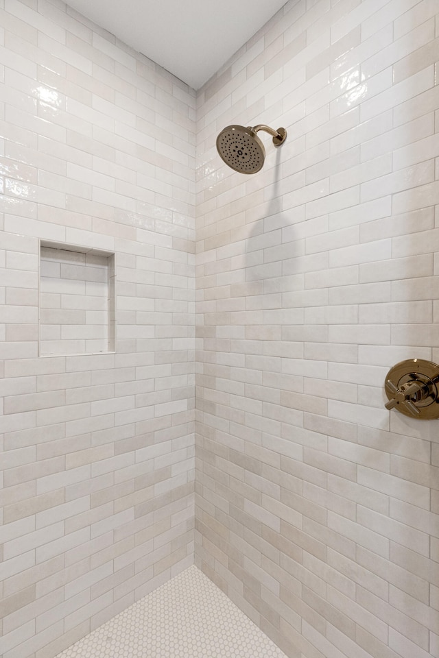 bathroom with a tile shower