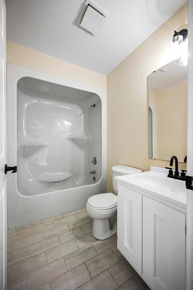 full bathroom with tile floors, shower / bathtub combination, vanity with extensive cabinet space, and toilet