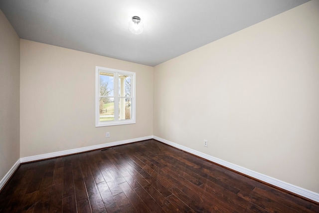 spare room featuring dark hardwood / wood-style floors