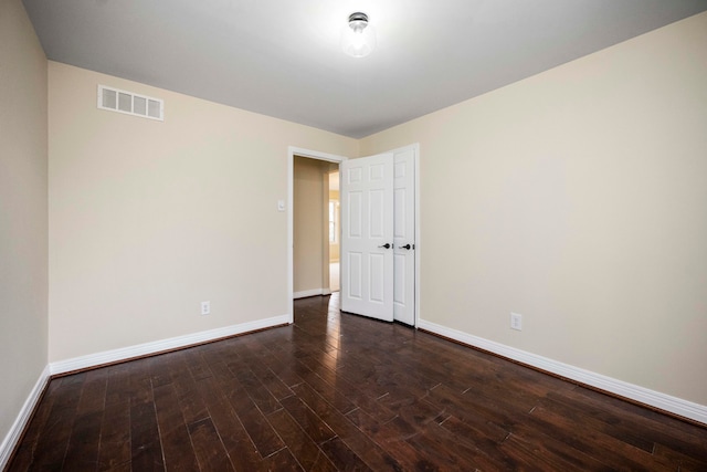 unfurnished room featuring dark wood-type flooring