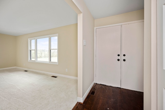 interior space featuring dark colored carpet