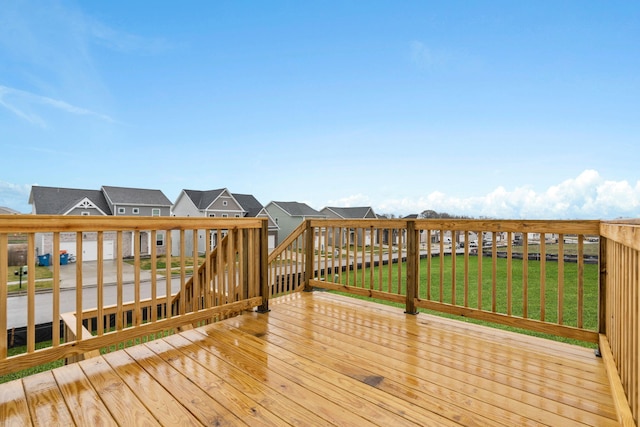 wooden deck featuring a yard