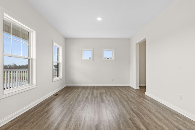 empty room with dark wood-type flooring