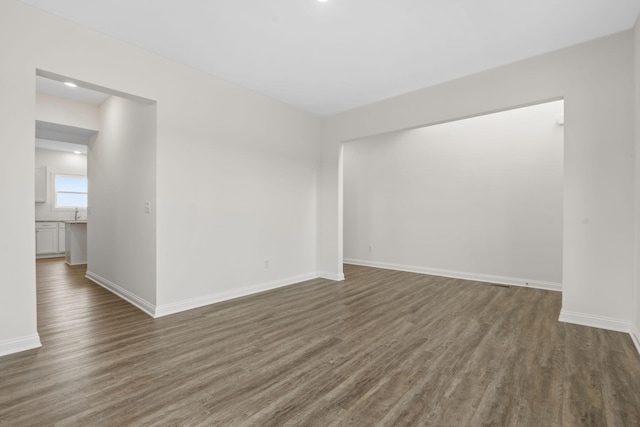 empty room featuring dark hardwood / wood-style flooring