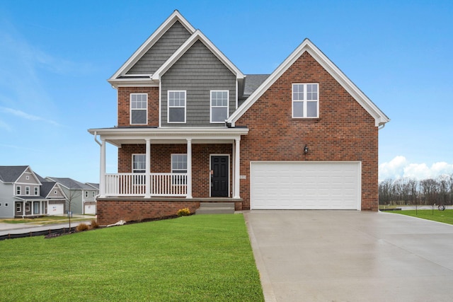 view of front of home with covered porch, a garage, and a front yard