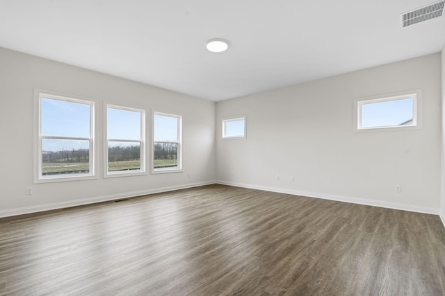 empty room featuring dark hardwood / wood-style flooring