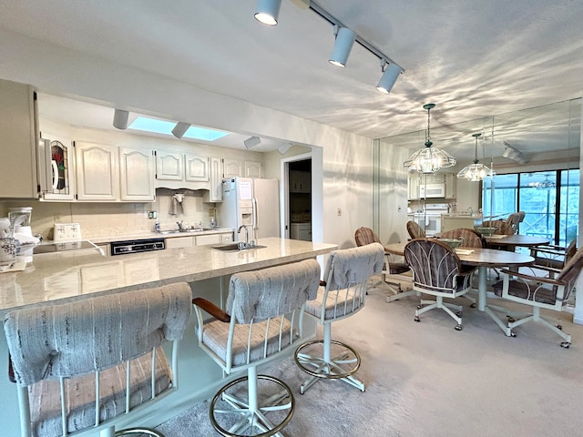46-1 Woodson Bend Resort, Bronston, KY 42518 - kitchen with white appliances, a peninsula, a sink, pendant lighting, and backsplash
