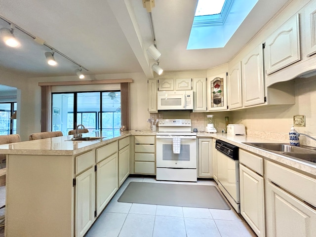 46-1 Woodson Bend Resort, Bronston, KY 42518 - kitchen featuring light tile patterned floors, a peninsula, a skylight, white appliances, and a sink