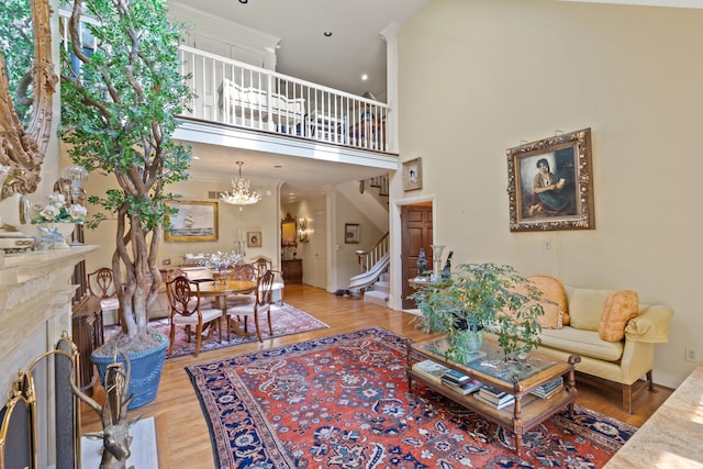 living room featuring a high ceiling, hardwood / wood-style flooring, and a chandelier