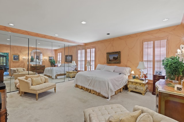 carpeted bedroom featuring multiple windows