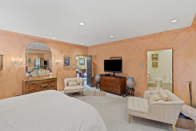 bedroom featuring connected bathroom and carpet floors