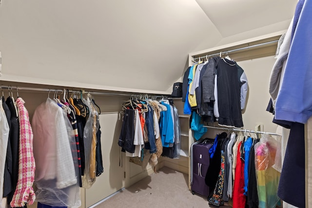 spacious closet featuring lofted ceiling and carpet floors