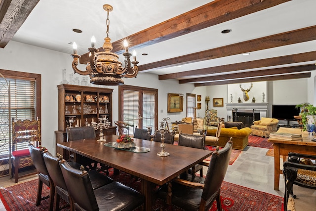 dining space with beam ceiling and a notable chandelier