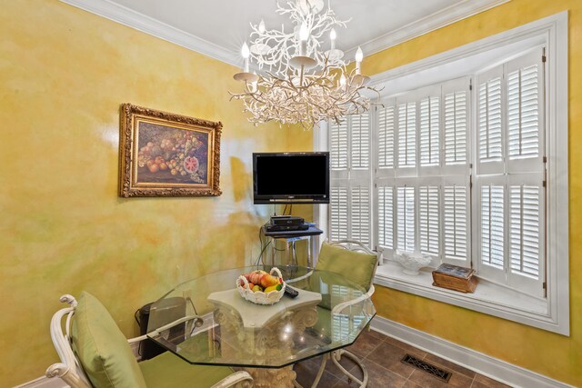 dining space with tile floors, ornamental molding, and an inviting chandelier