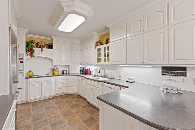 kitchen featuring white dishwasher, white cabinetry, wall oven, sink, and dark tile floors