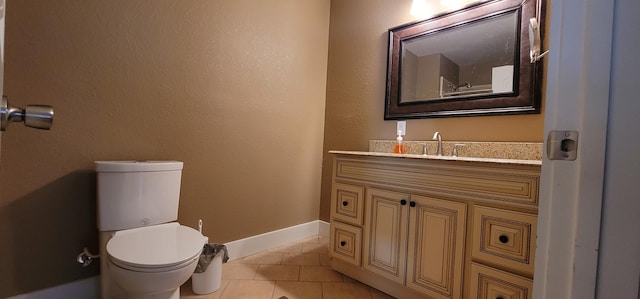 bathroom with vanity, tile patterned floors, and toilet