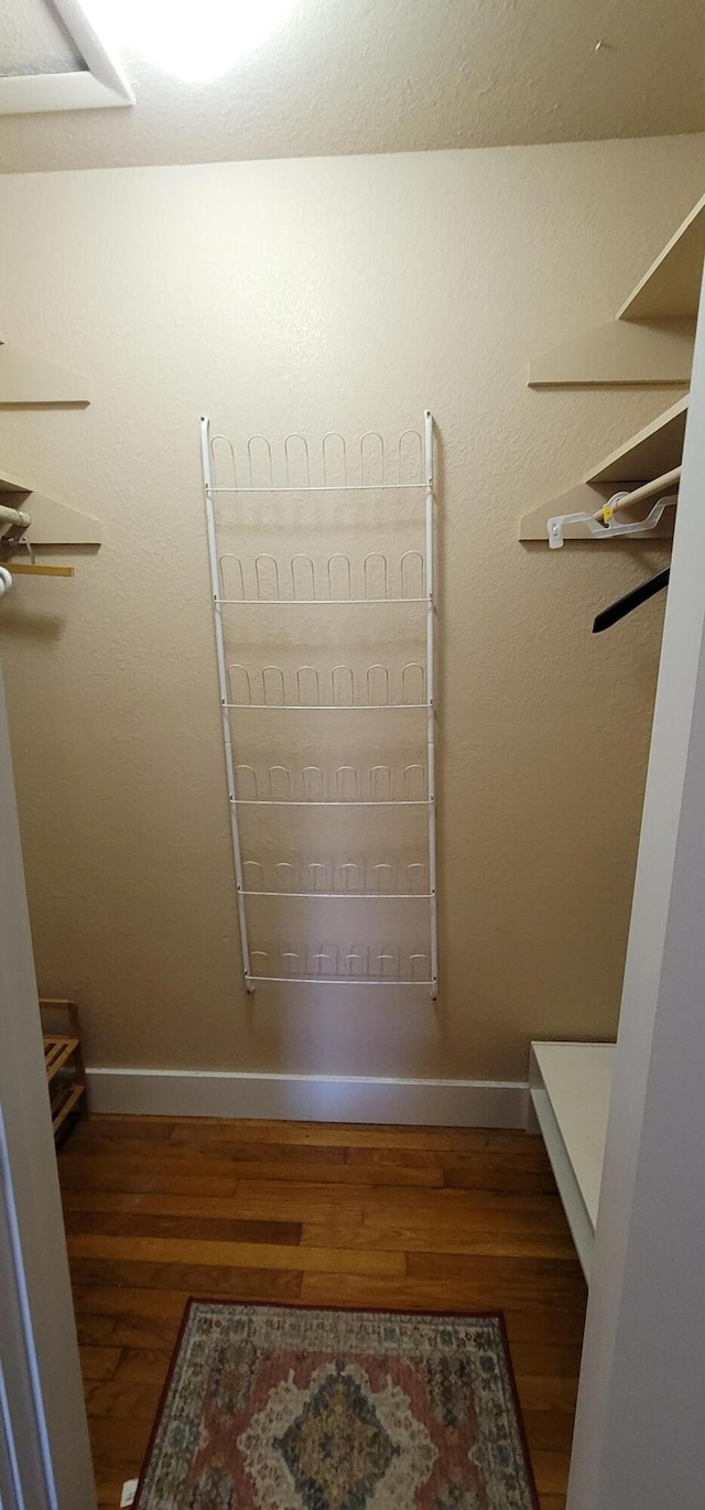 walk in closet featuring dark hardwood / wood-style flooring