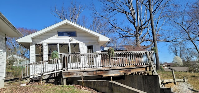 back of house with a deck