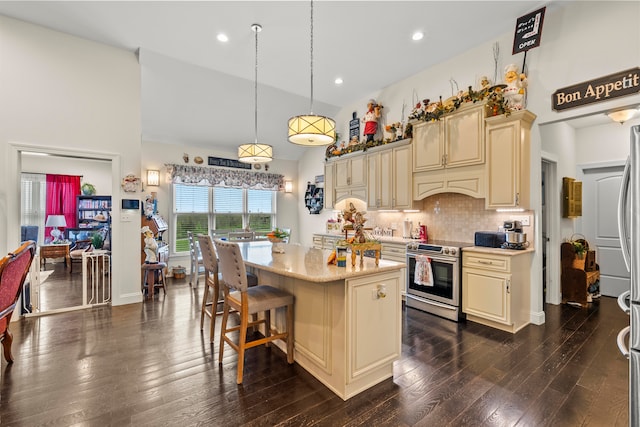 kitchen with decorative light fixtures, tasteful backsplash, dark hardwood / wood-style floors, stainless steel range with electric cooktop, and a center island