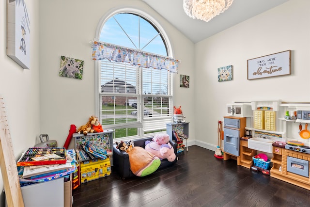 rec room featuring a notable chandelier, lofted ceiling, and dark hardwood / wood-style floors