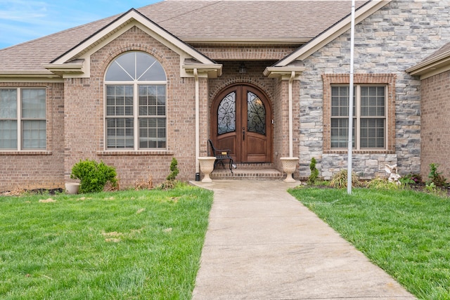 property entrance with a lawn