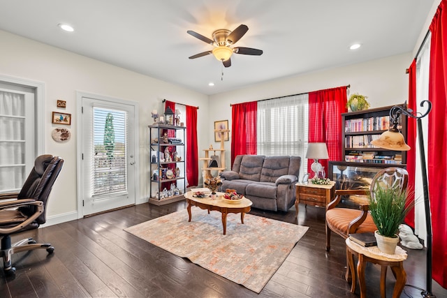 living room with dark hardwood / wood-style floors and ceiling fan