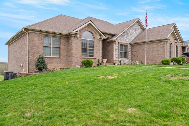 view of front of house with a front yard and central AC unit