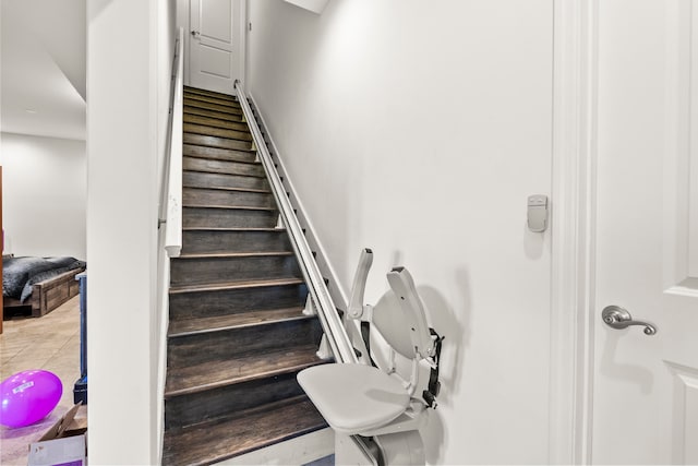 stairway featuring light tile floors