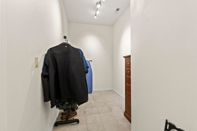 spacious closet featuring light tile flooring