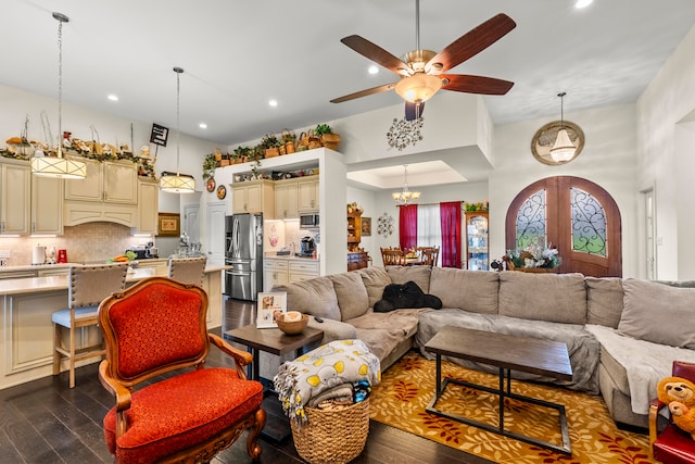 living room featuring french doors, ceiling fan with notable chandelier, and dark hardwood / wood-style floors