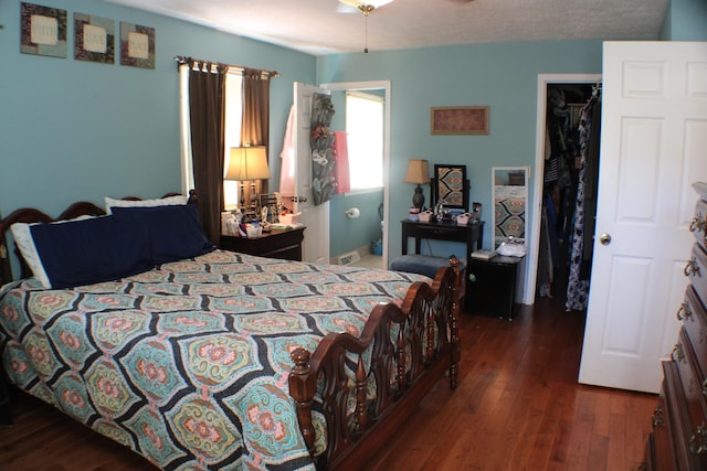 bedroom with dark hardwood / wood-style floors and a closet