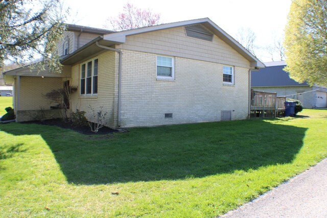 view of side of property with a deck and a yard