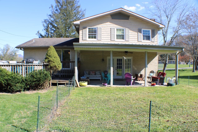 rear view of house featuring a yard, a patio area, and an outdoor living space