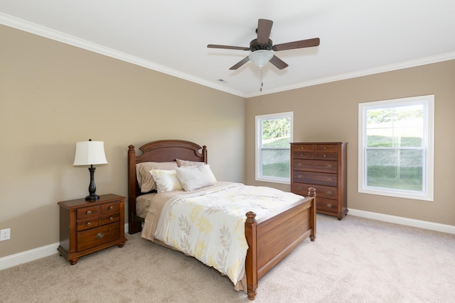 bedroom with light colored carpet, ceiling fan, and crown molding