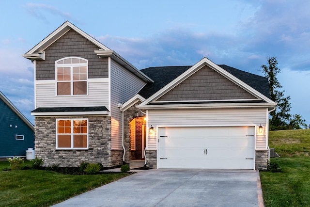 craftsman-style home featuring a front lawn and a garage