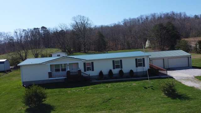 ranch-style house featuring covered porch, a garage, and a front yard