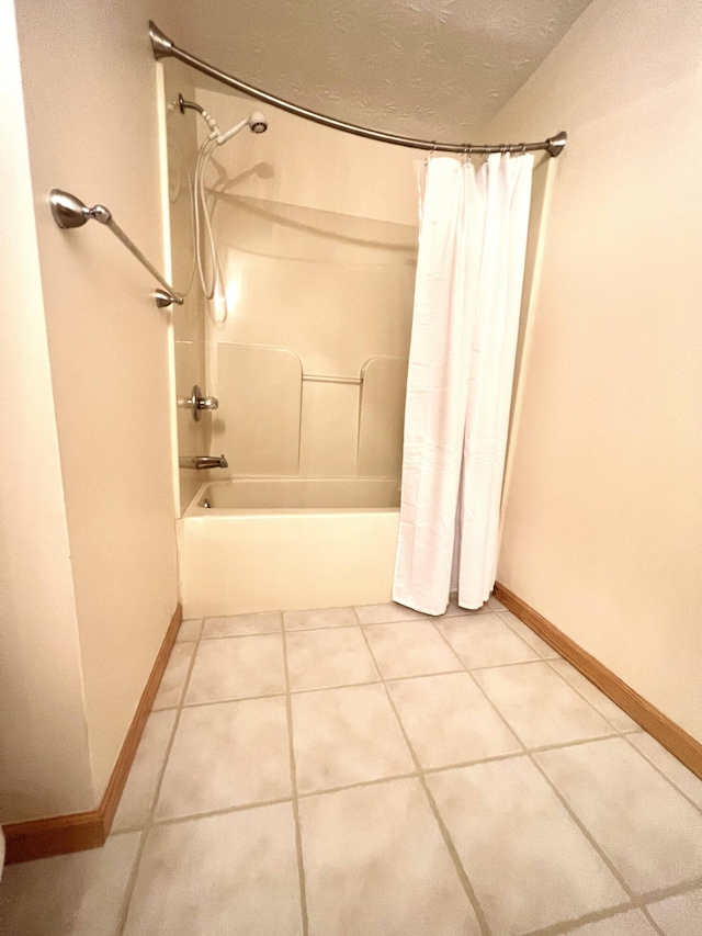 bathroom featuring tile patterned flooring, a textured ceiling, and shower / tub combo with curtain