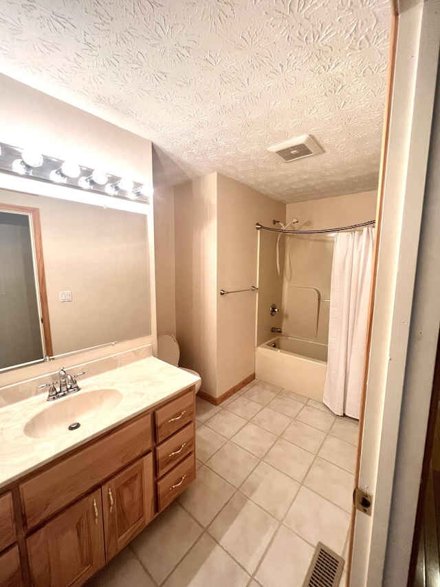 bathroom with tile patterned floors, shower / bath combination with curtain, a textured ceiling, and vanity