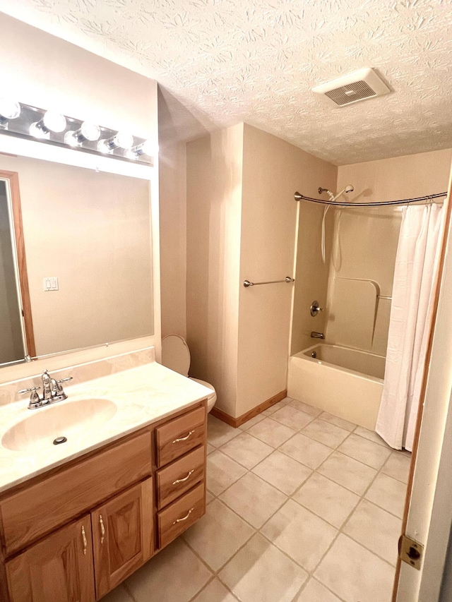 bathroom featuring tile patterned flooring, vanity, a textured ceiling, and shower / bath combo