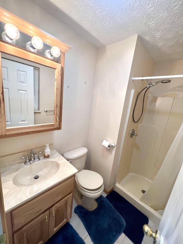 bathroom featuring toilet, a shower, and a textured ceiling