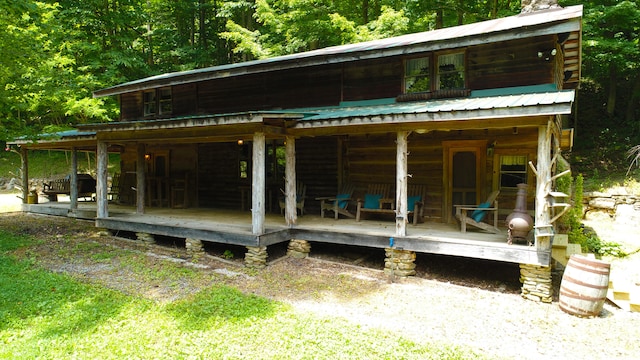 rear view of house with covered porch